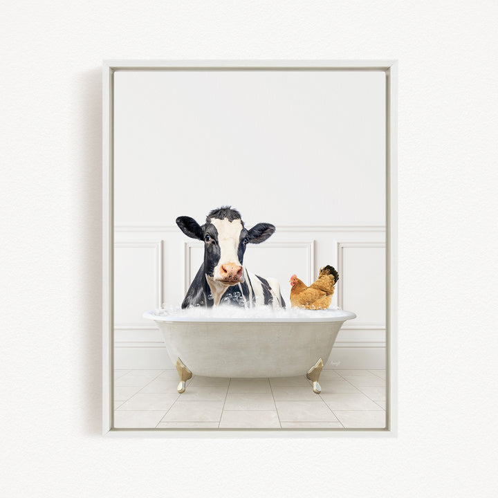 A black and white cow is sitting in a white bathtub, with a chicken standing nearby, in a white-walled room.