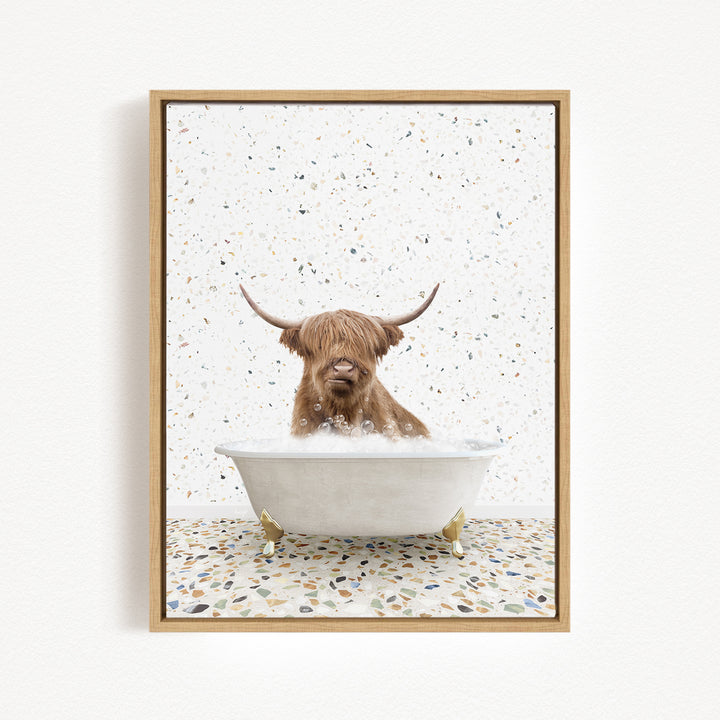 A brown cow with long horns is sitting in a white bathtub filled with water, surrounded by a speckled tiled floor.