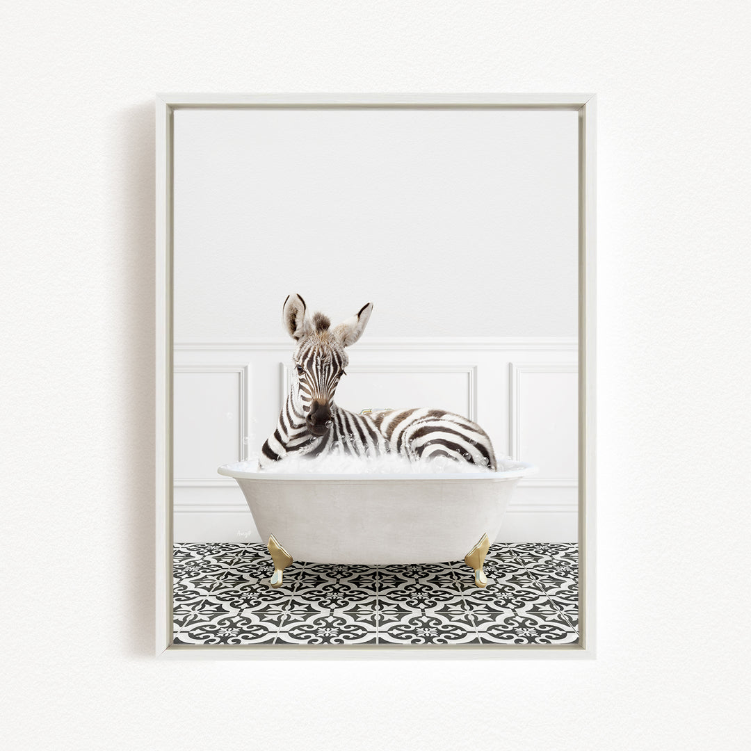 A zebra is sitting in a white bathtub, surrounded by a black and white patterned floor.