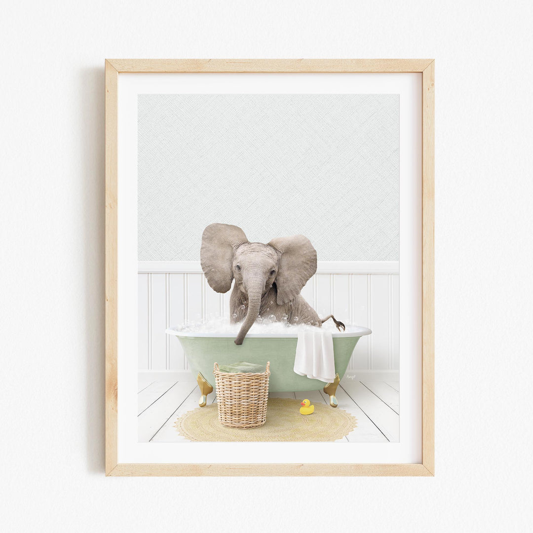 A baby elephant sitting in a green bathtub filled with water, surrounded by rubber ducks and a towel.