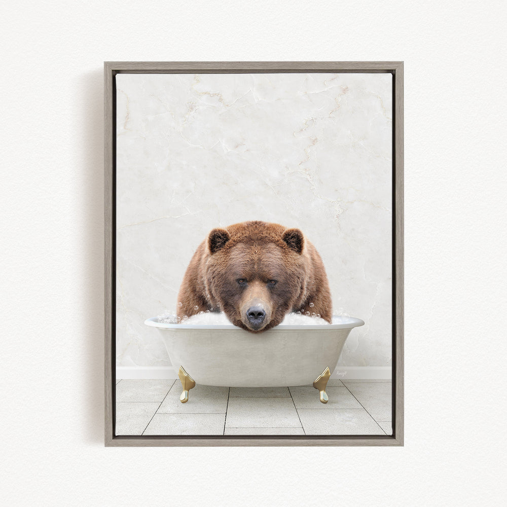 A brown bear is sitting in a white bathtub, appearing to be enjoying a relaxing bath.