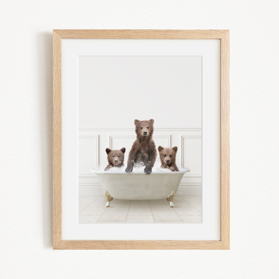 A framed image of three bears sitting in a bathtub, with one bear sitting in the center and the other two bears sitting on either side.