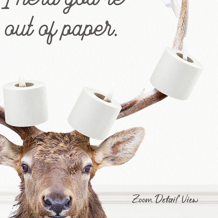A deer with antlers wearing toilet paper rolls on its head, with the text "I'm out of paper."