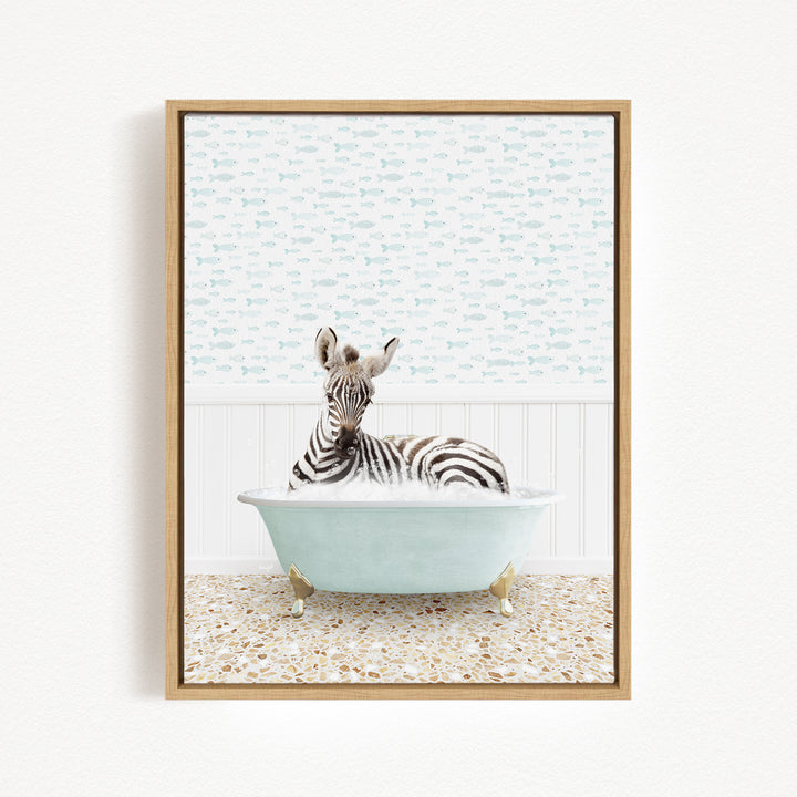 A zebra is sitting in a light blue bathtub, surrounded by a patterned tile floor and a white wall with a fish-themed wallpaper.