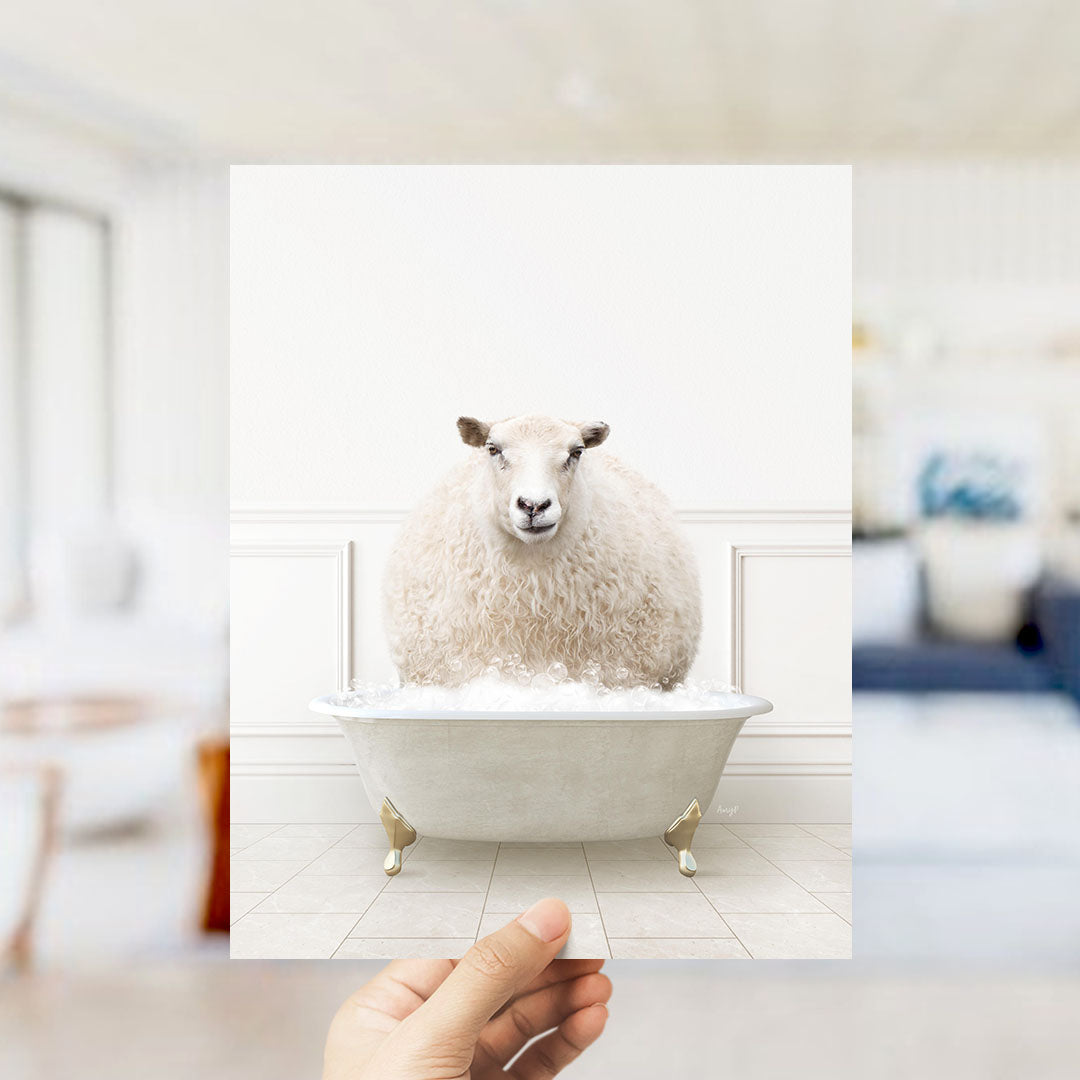 A fluffy white sheep sitting in a white bathtub filled with bubbles, with a blurred background suggesting a bathroom setting.
