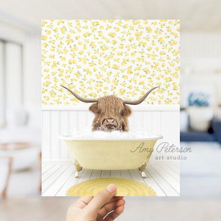 a person holding up a picture of a bull in a bathtub