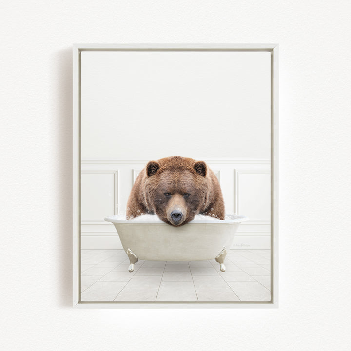 A brown bear is sitting in a white bathtub, appearing to be enjoying a relaxing bath.