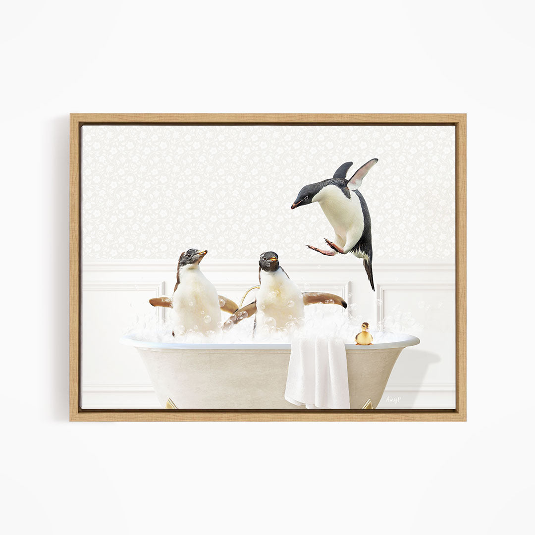 A framed image depicting three penguins sitting in a bathtub, with one penguin jumping out of the tub.