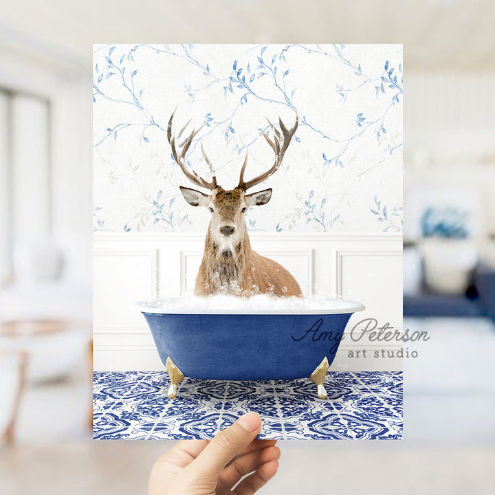 a hand holding a card with a picture of a deer in a bathtub