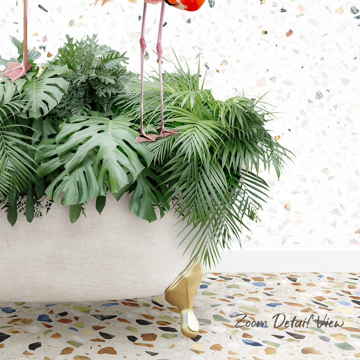 A lush, green plant with large leaves sits in a white bathtub, with a pair of pink flamingos perched on the edge of the tub.
