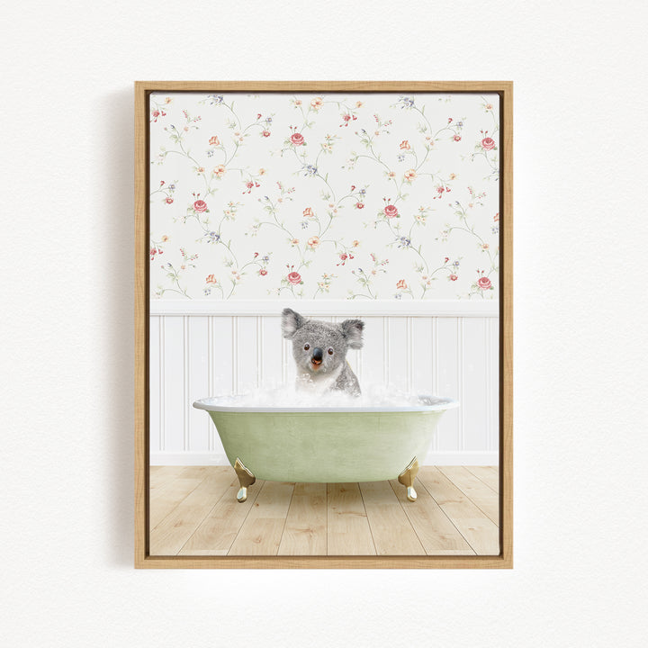 A koala bear sitting in a green bathtub filled with water, surrounded by a floral wallpaper.