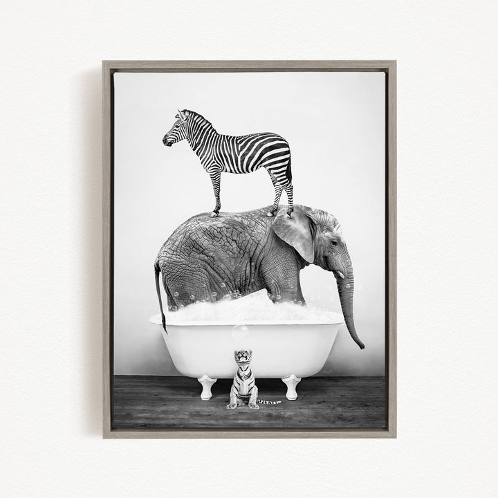 A zebra stands on top of an elephant in a bathtub, with a small tiger sitting in the tub below.