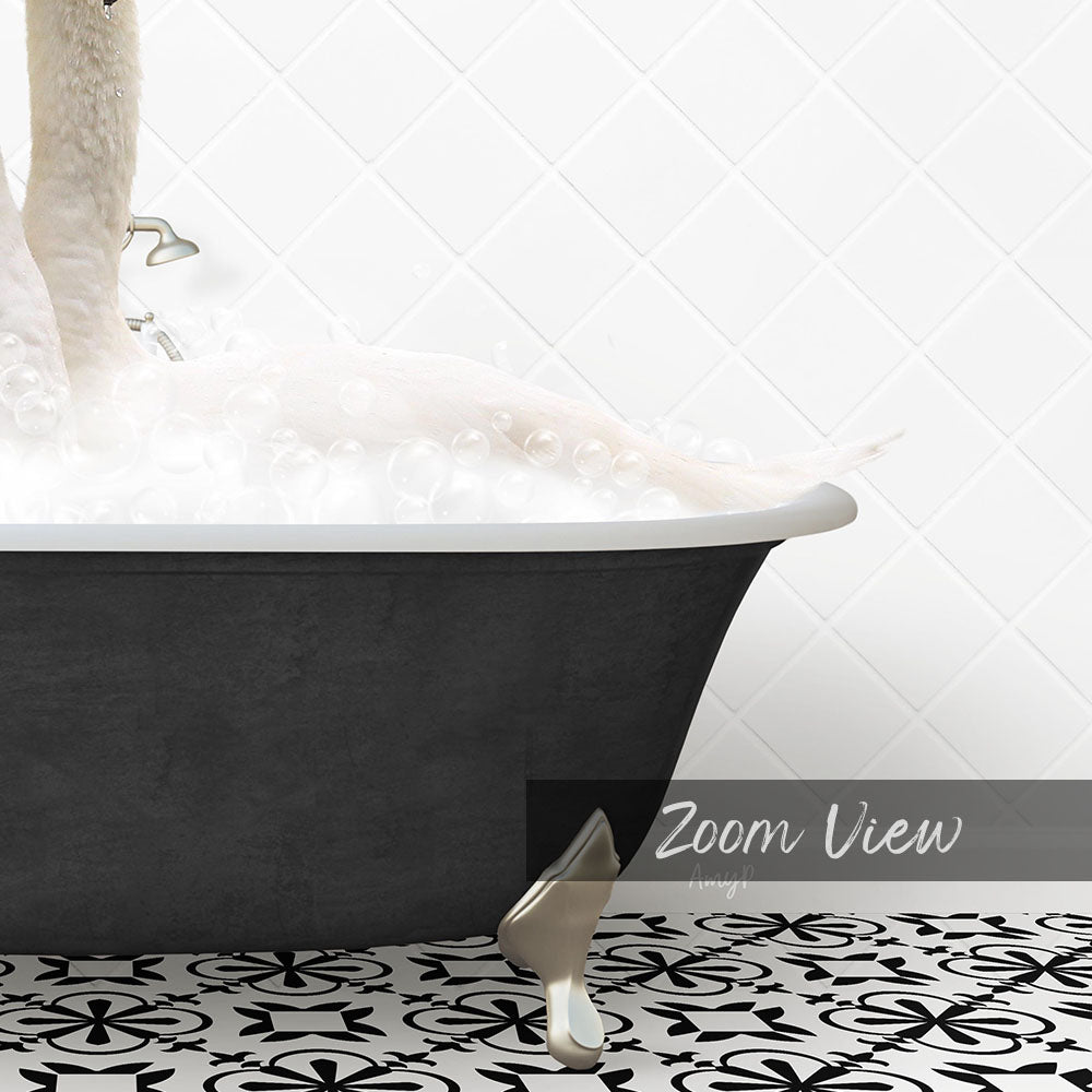 A black bathtub filled with bubbles, with a gold faucet and a gold bathtub leg visible.