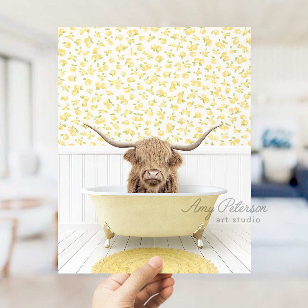 a person holding up a picture of a cow in a bathtub