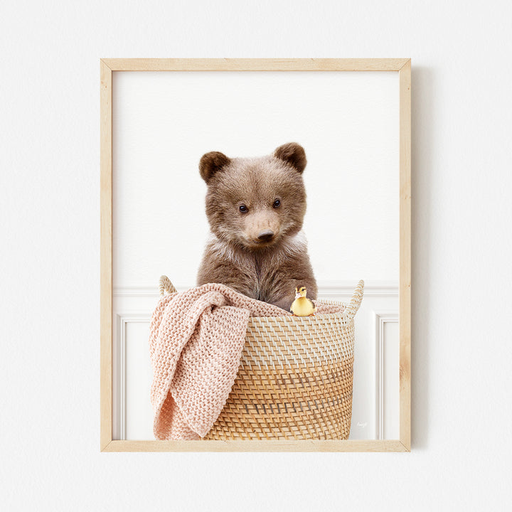 a small brown bear sitting in a basket