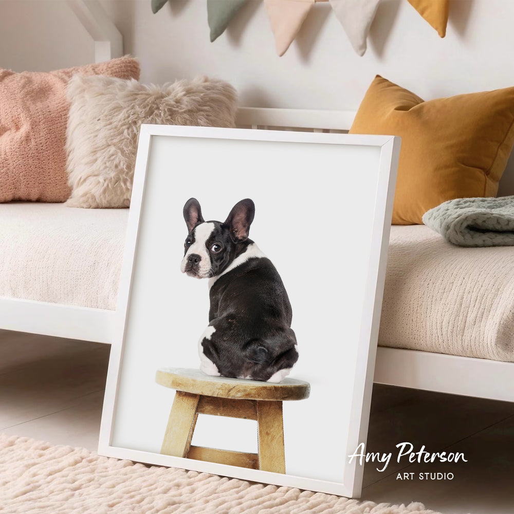 A framed image of a black and white dog sitting on a wooden stool in a cozy living room setting.