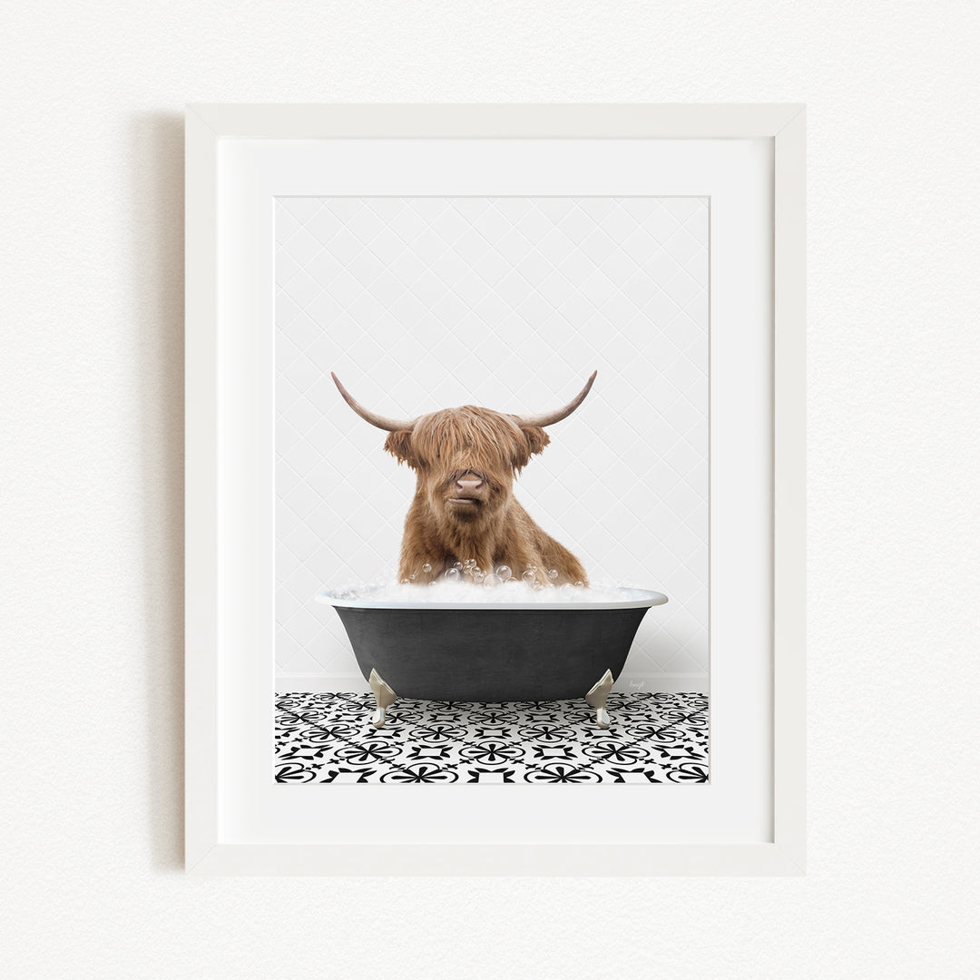 A brown Highland cow with long horns is sitting in a black bathtub filled with water, creating a whimsical and playful scene.