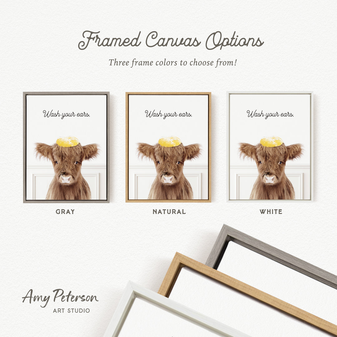 three framed canvas options featuring a cow with a yellow hat on its head, each with a different frame color: gray, natural, and white.