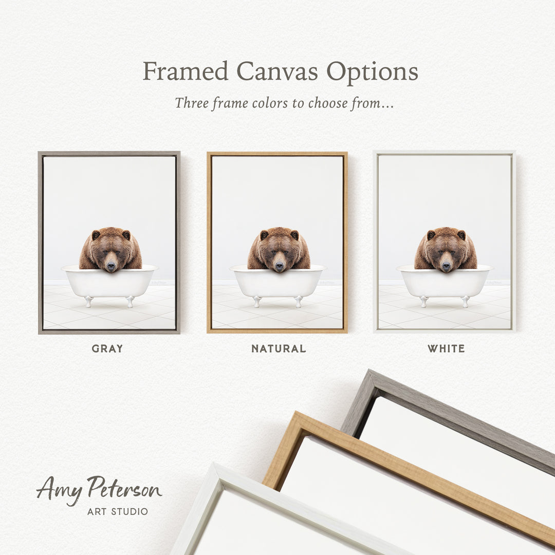 three framed canvas options, each featuring a brown bear sitting in a bathtub. The options include a gray frame, a natural frame, and a white frame.