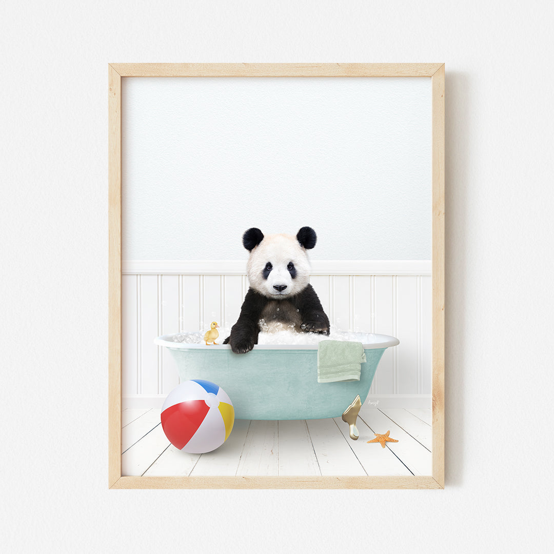 a panda bear sitting in a bathtub with a beach ball