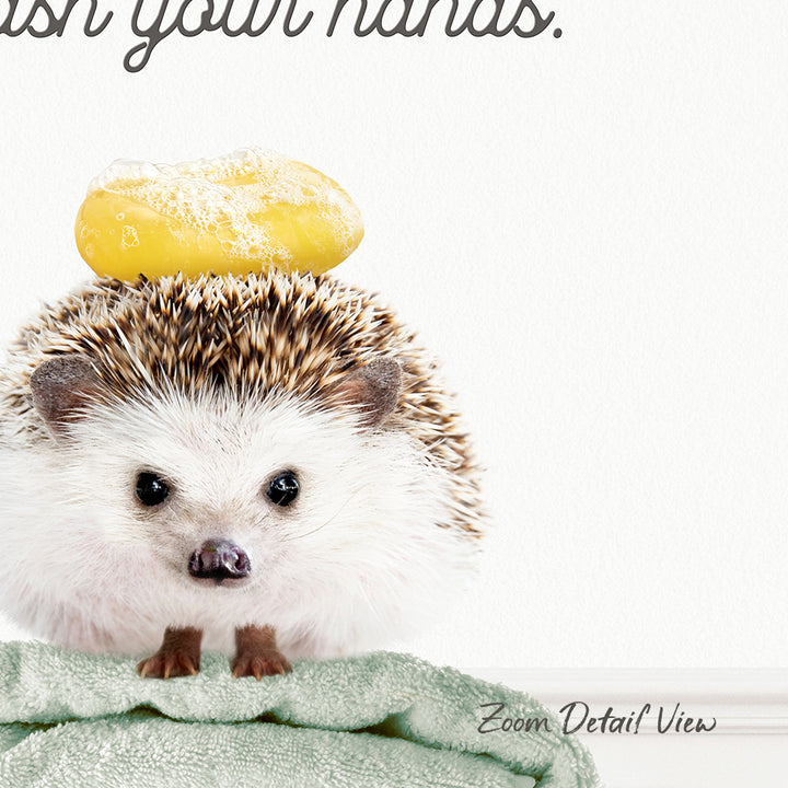 A hedgehog sitting on a towel with a yellow object on its head.