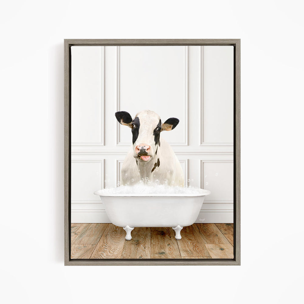A black and white cow is sitting in a white bathtub filled with water, creating a whimsical and humorous scene.