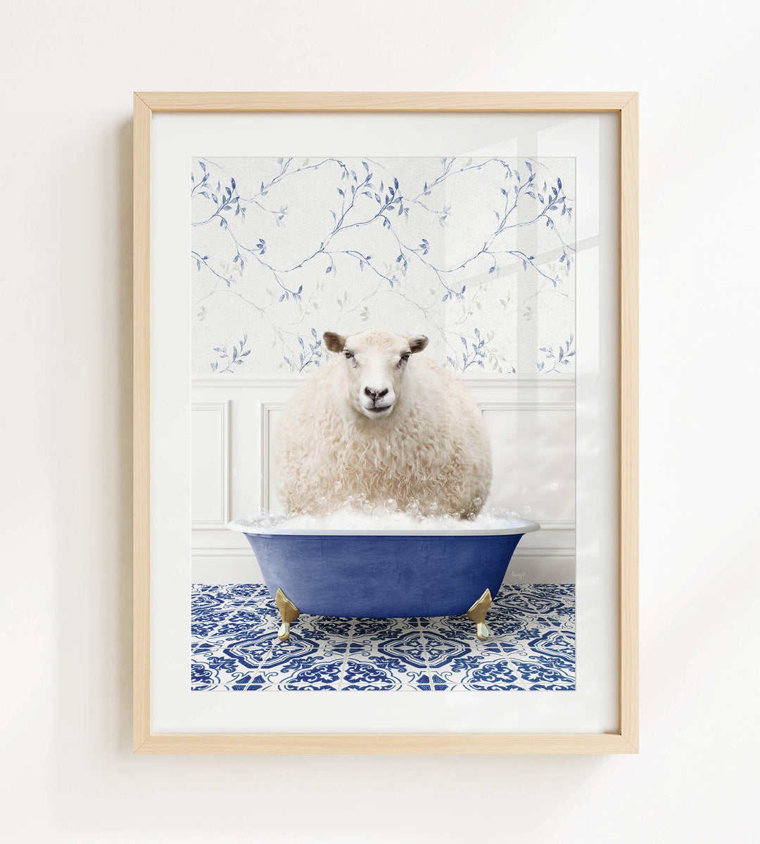 A fluffy white sheep sits in a blue bathtub, surrounded by a patterned tile floor and a white wall with blue floral wallpaper.