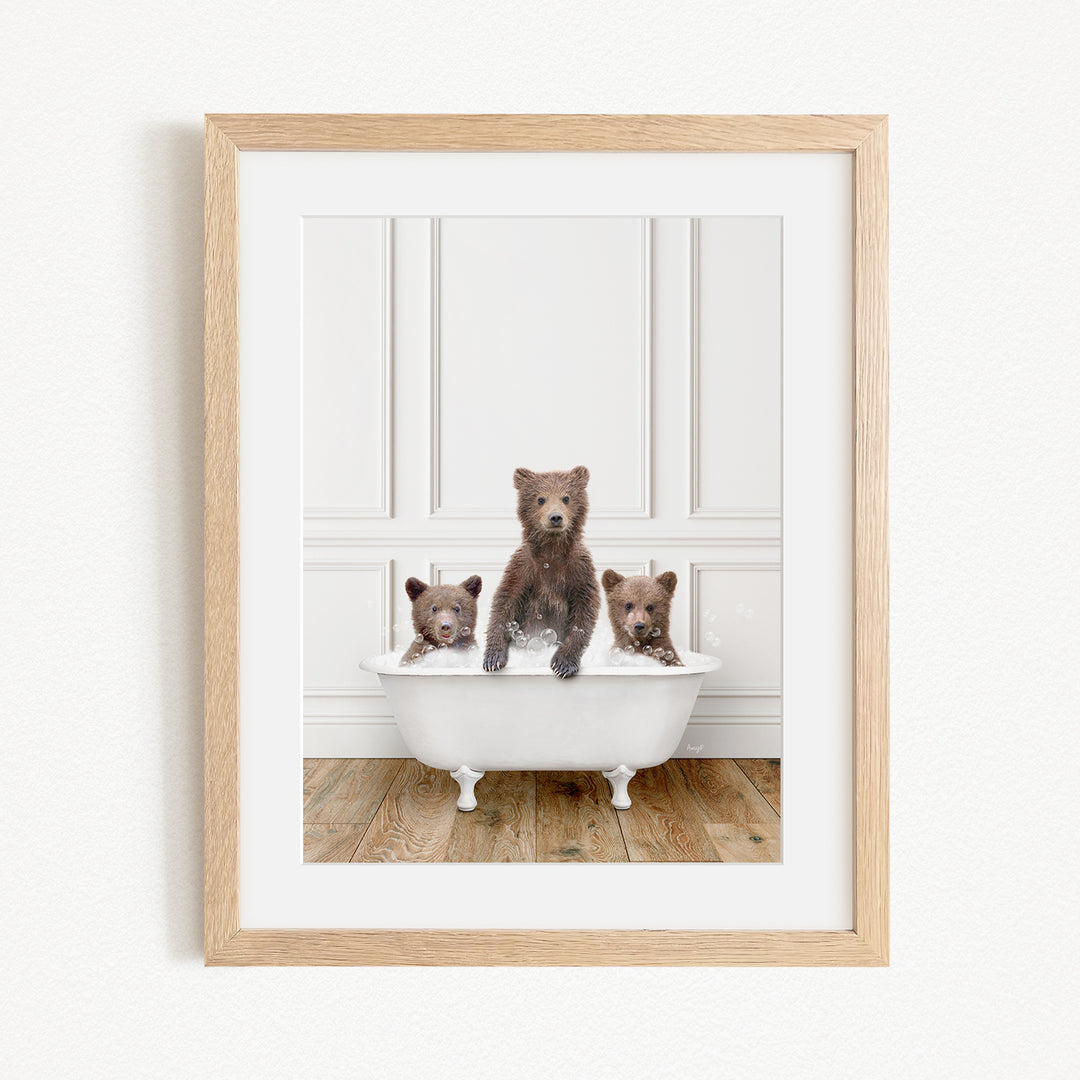 A framed image of three bears sitting in a white bathtub, with one bear sitting in the center and the other two bears sitting on either side.
