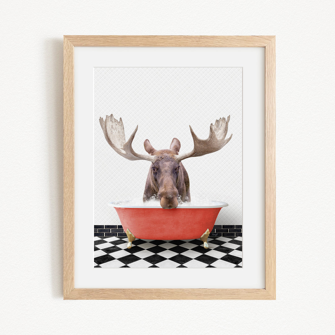 A moose with large antlers is sitting in a red bathtub, surrounded by a black and white checkered floor.