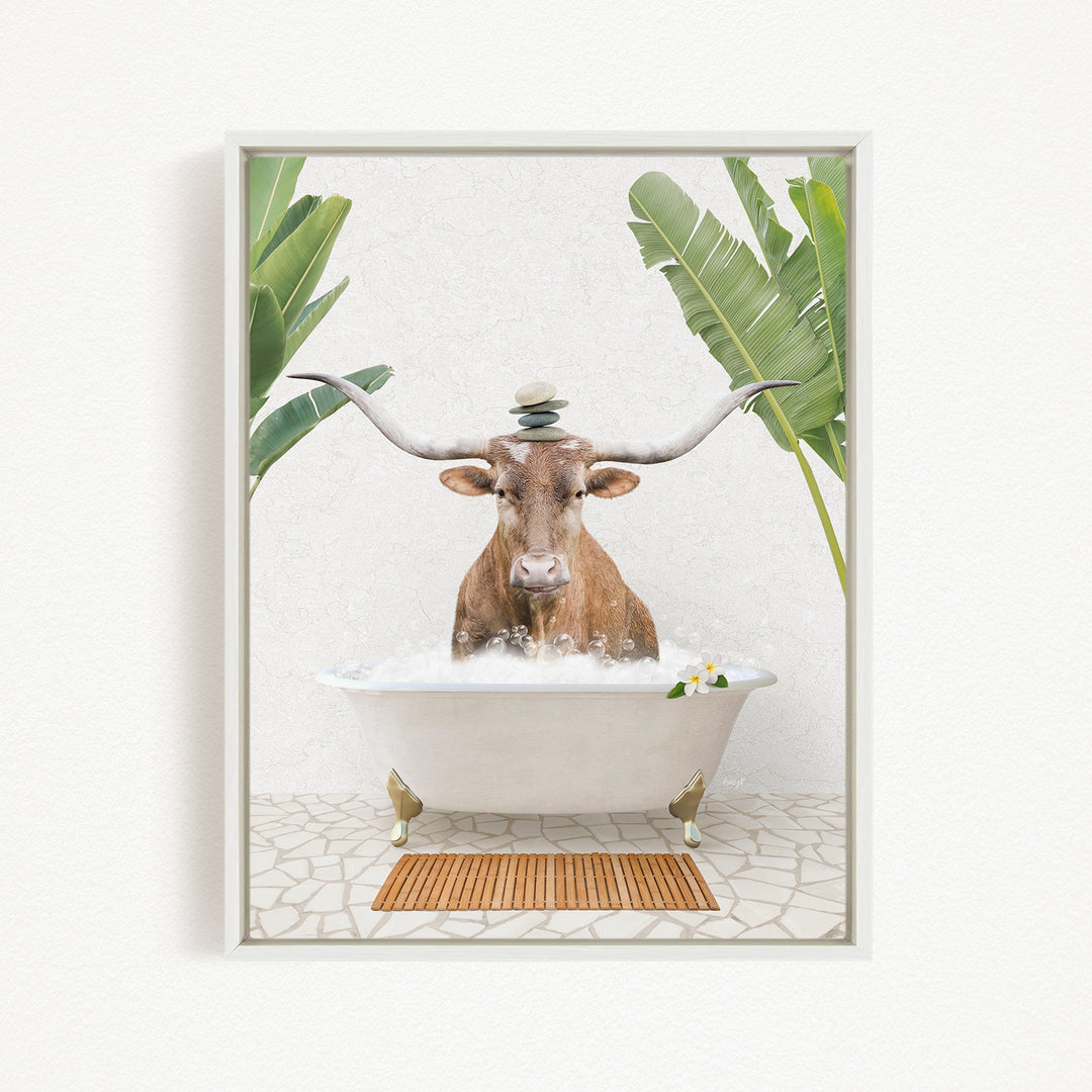 A brown cow with large horns is sitting in a white bathtub filled with water, surrounded by green leaves and a wooden mat on the floor.