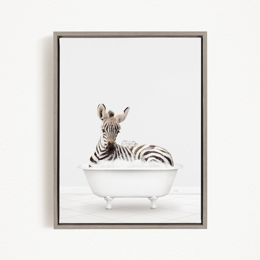 A zebra is sitting in a white bathtub filled with bubbles, creating a whimsical and playful scene.