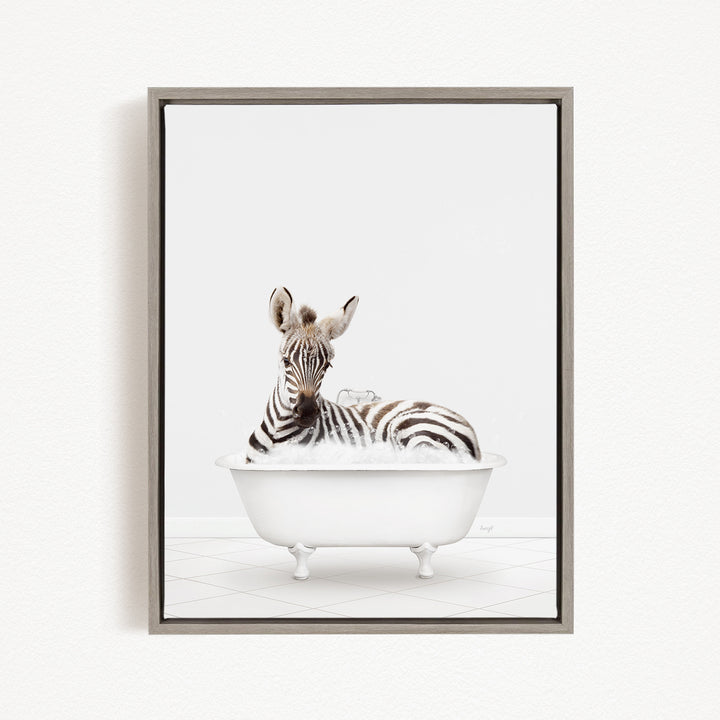 A zebra is sitting in a white bathtub filled with bubbles, creating a whimsical and playful scene.