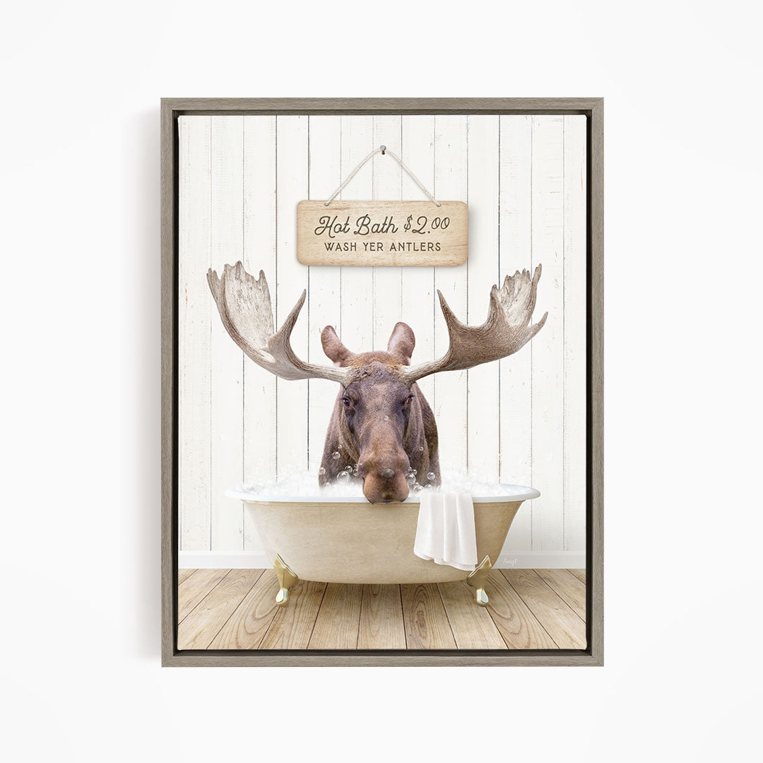 A moose is sitting in a bathtub, with a sign above it that reads "Hot Bath $2.00 Wash Your Antlers".