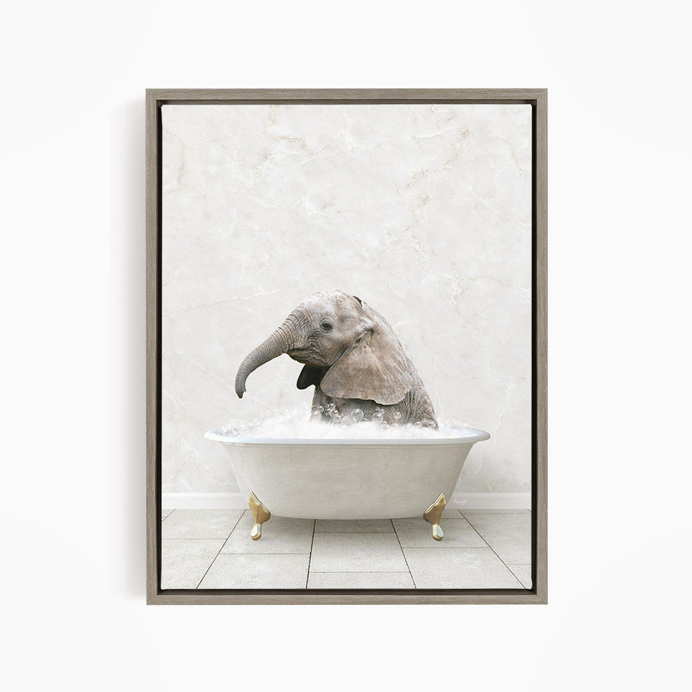 A baby elephant sitting in a white bathtub filled with water, with its trunk submerged in the water.