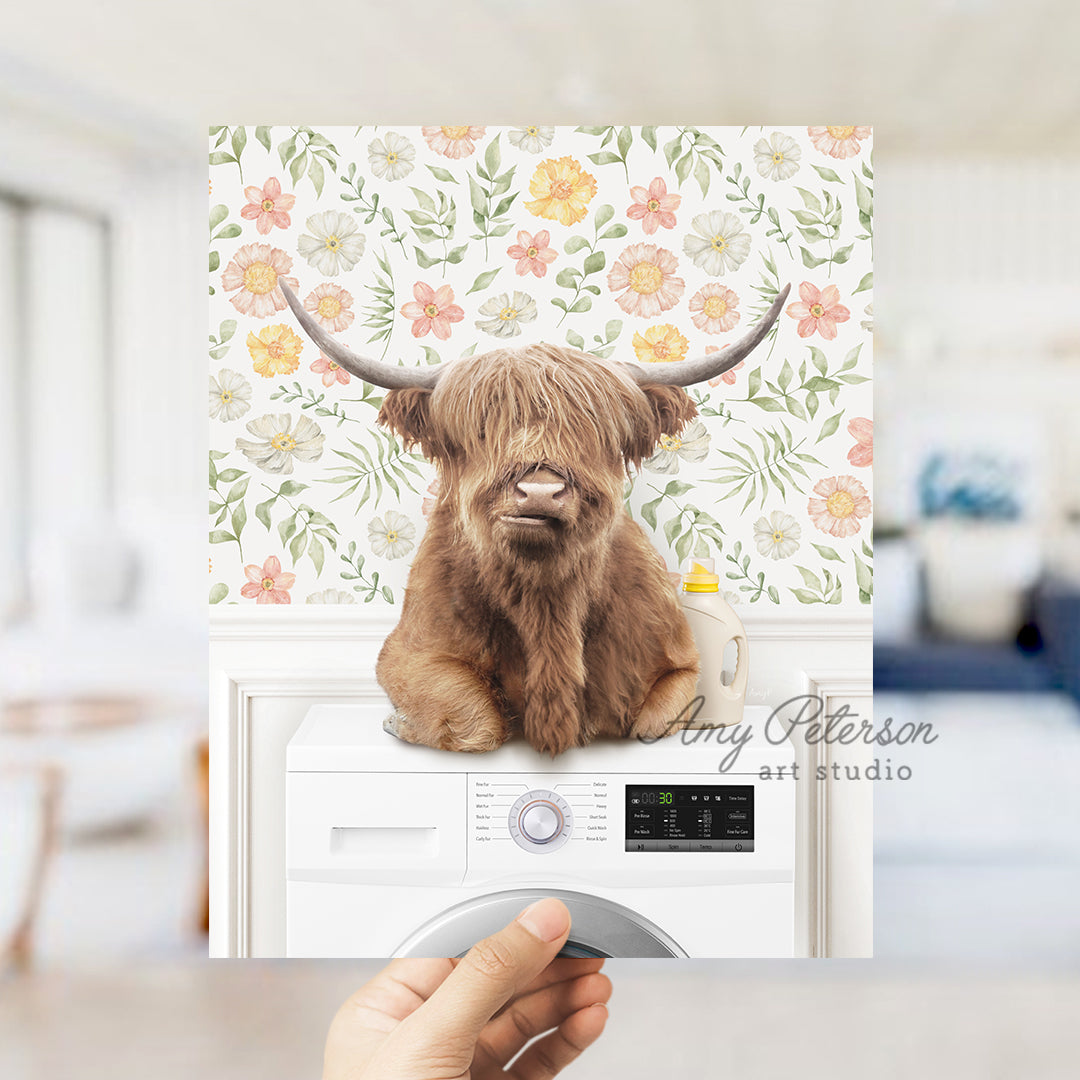 a person holding a card with a picture of a highland cow on it