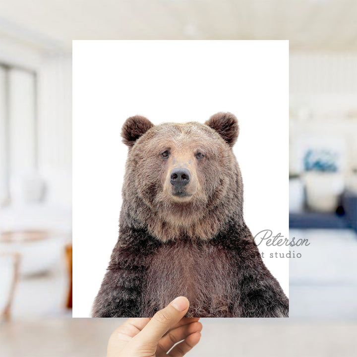 a person holding up a picture of a bear