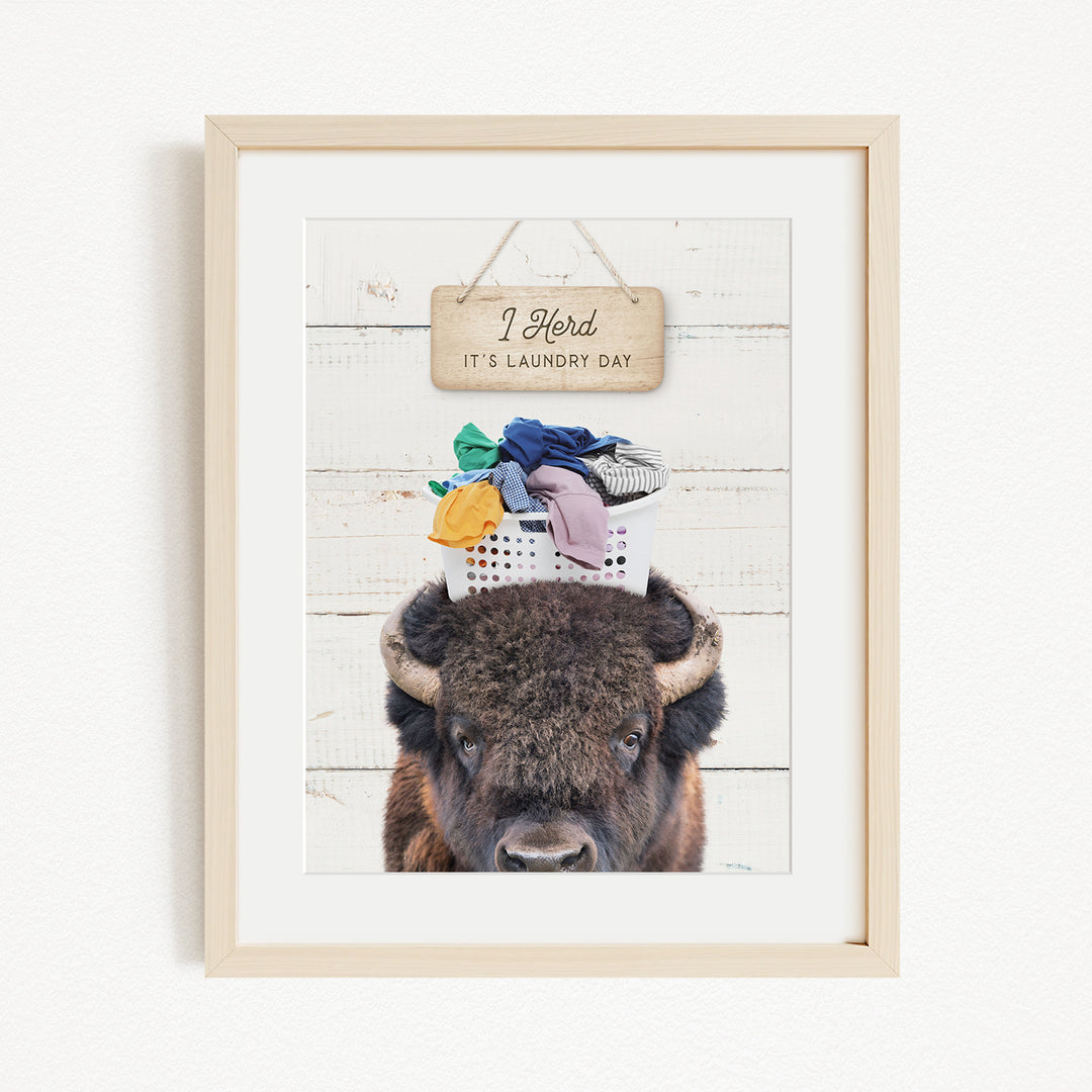 A framed image of a bison with a sign above it that says "I herd, it's laundry day".