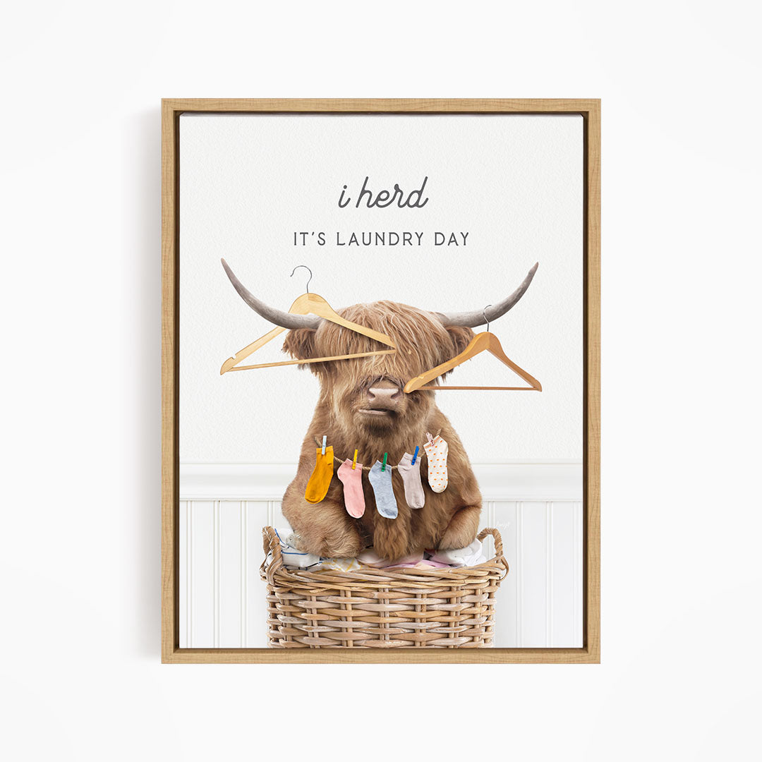 A brown cow with horns sits in a wicker basket, holding clothes on its horns and surrounded by clothes hanging on a clothesline.