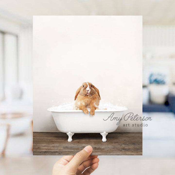 a person holding up a picture of a dog in a bathtub