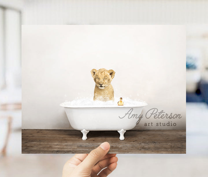 a hand holding up a card with a picture of a lion in a bathtub