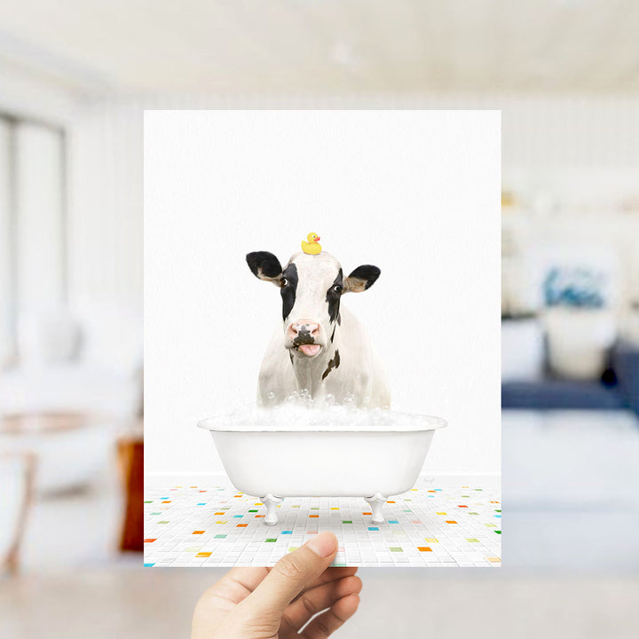 A cow is sitting in a bathtub filled with water, with a rubber duck perched on its head.