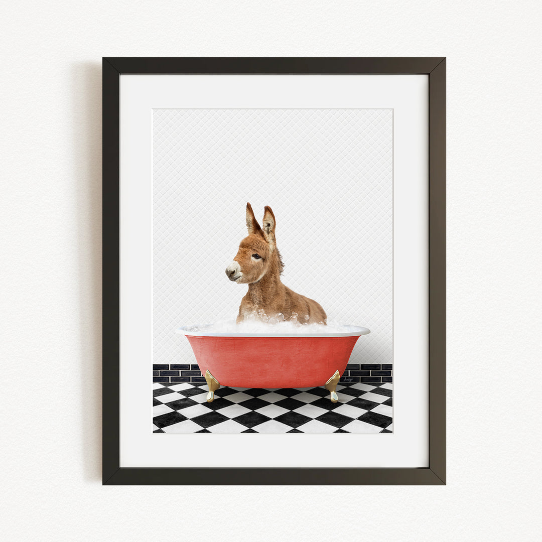 A donkey is sitting in a red bathtub filled with water, surrounded by a black and white checkered floor.