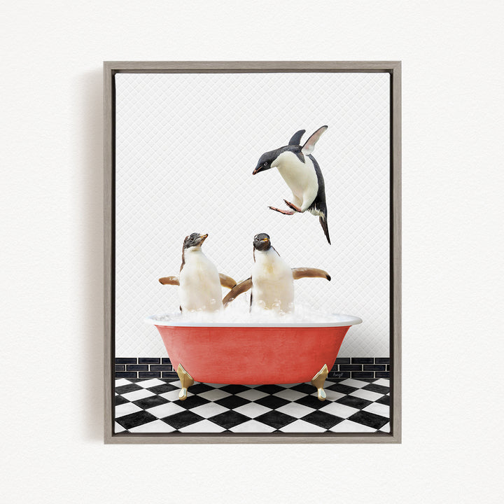 A framed image depicting three penguins in a red bathtub, with one penguin flying above the tub.