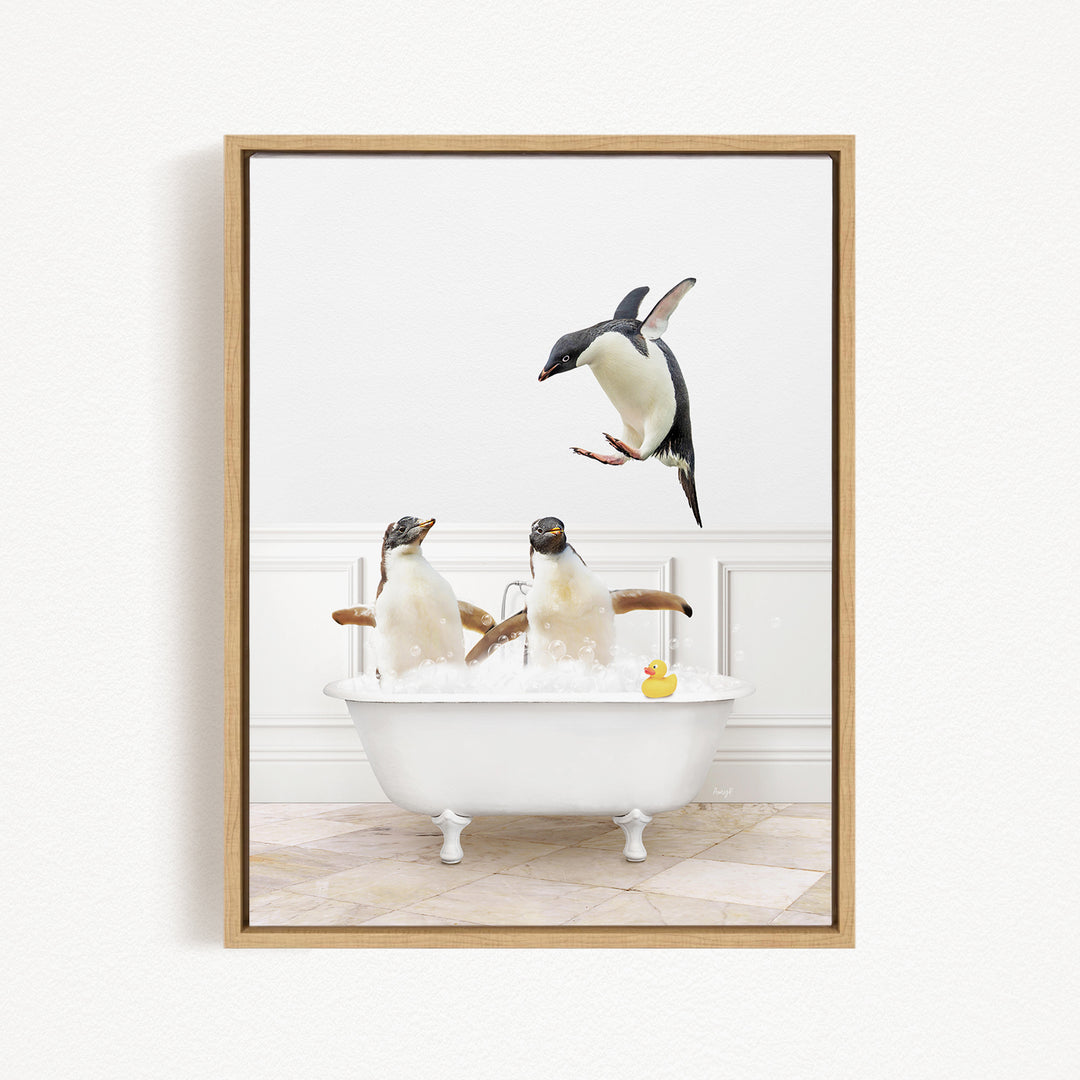 A framed image depicting two penguins sitting in a bathtub, with one penguin jumping out of the tub and another penguin sitting in the tub.