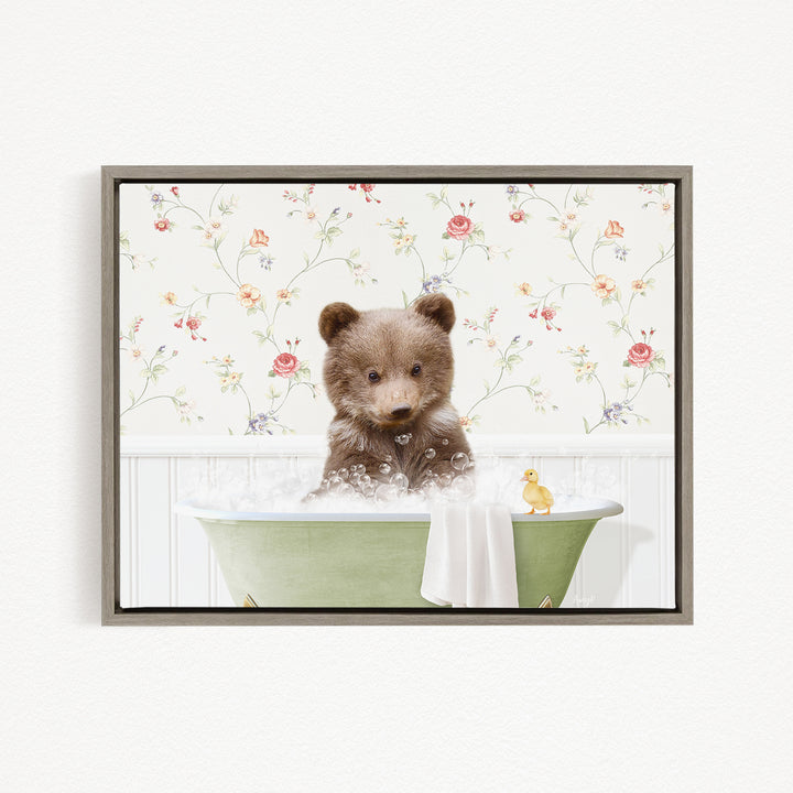 A cute brown bear sitting in a green bathtub filled with bubbles, surrounded by a floral wallpaper.