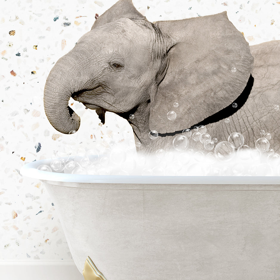 a baby elephant taking a bath in a bathtub