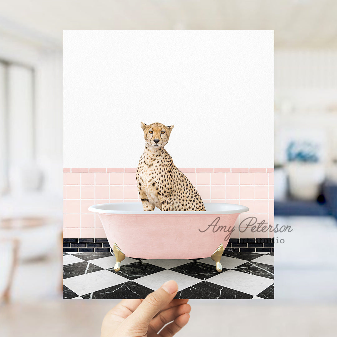 a hand holding a card with a cheetah sitting in a bathtub