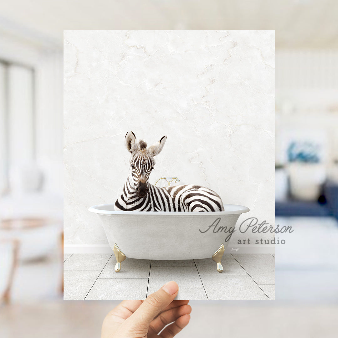 a hand holding a photo of a zebra in a bathtub