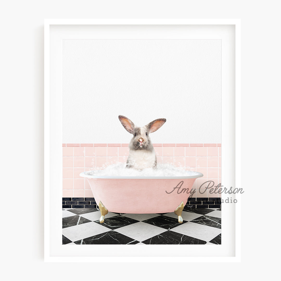 a rabbit sitting in a bathtub with a pink tile wall behind it