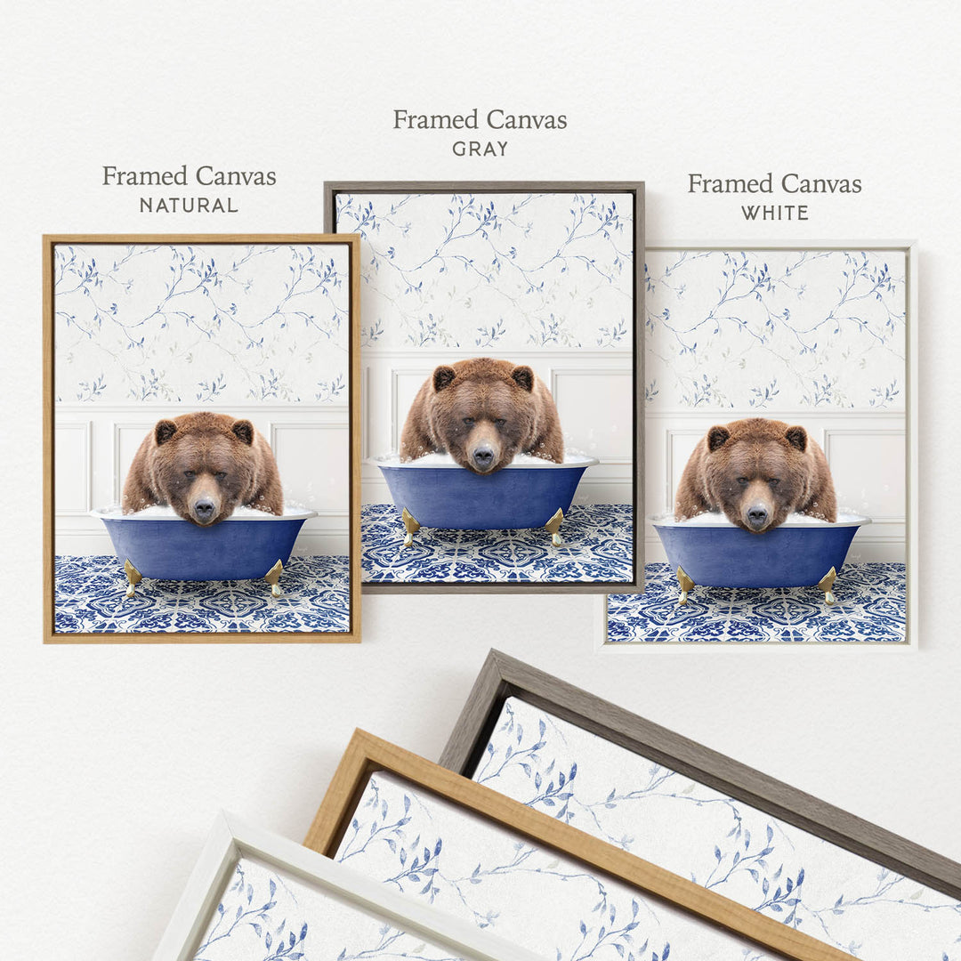 three framed pictures of a bear sitting in a blue bathtub, each with a different frame color: natural, gray, and white.